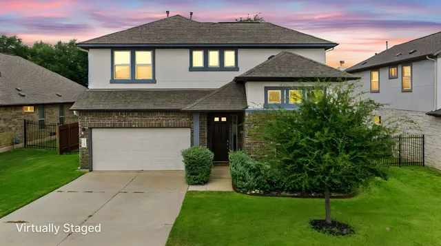 a front view of a house with a garden and plants