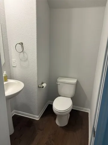 a white toilet sitting next to a shower