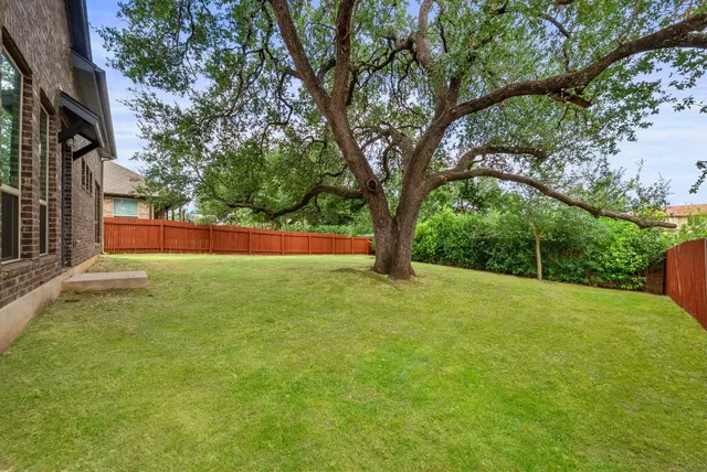 an aerial view of a house with swimming pool patio and outdoor seating
