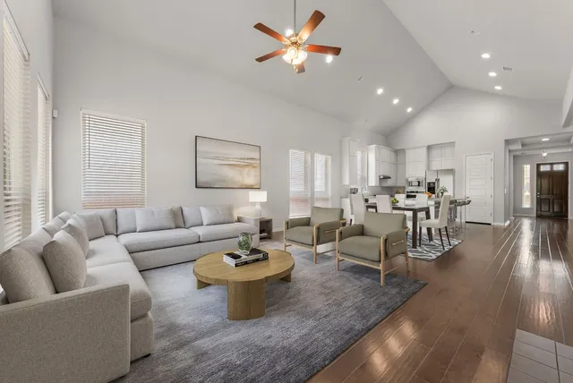 a living room with furniture and view of kitchen