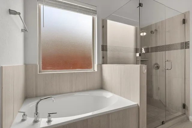 a bathroom with a bathtub and a shower