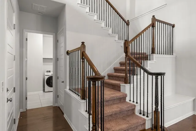 a view of entryway and hall with wooden floor