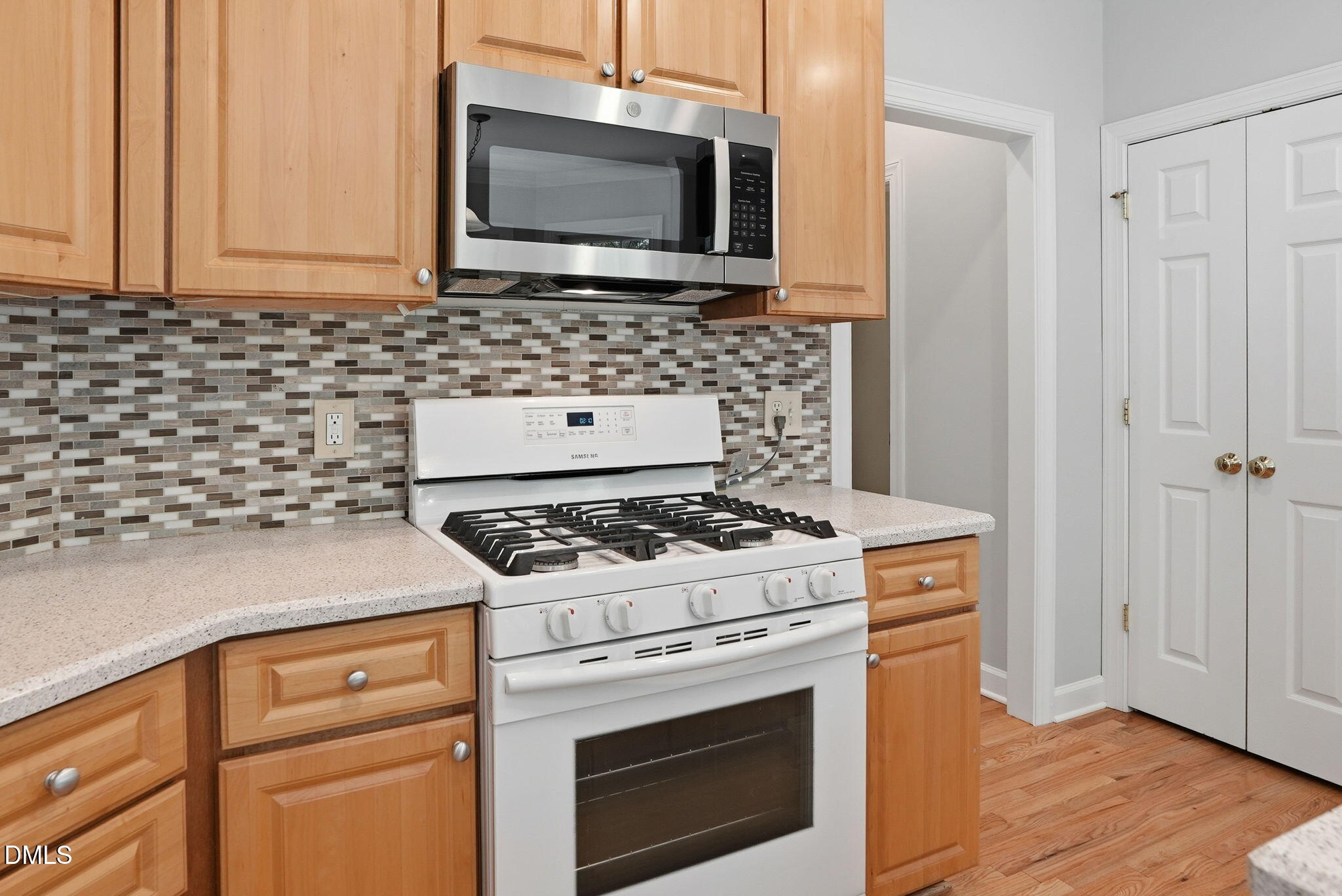 7 Morgans Ridge Lane Durham, NC 27707 - Photo 28 of 75 a kitchen with granite countertop a stove top oven microwave and cabinets