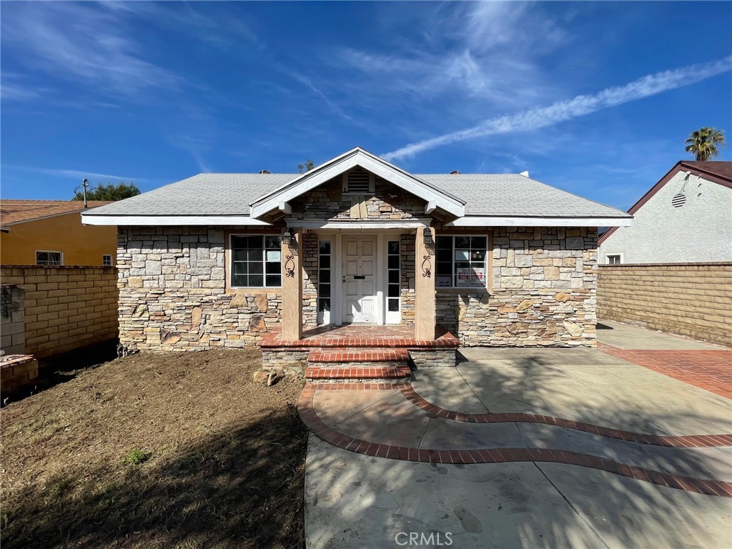 a front view of a house with garden