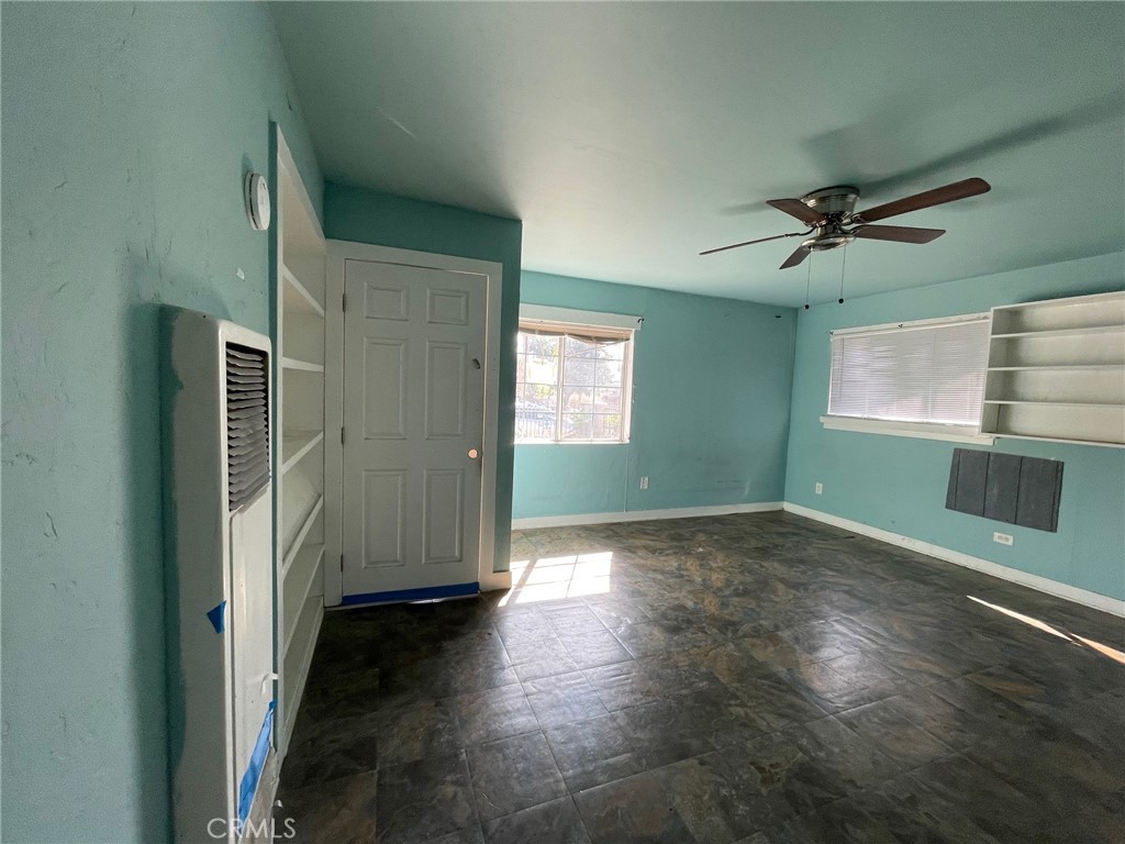 845 North Hagar Street San Fernando, CA 91340 - Photo 16 of 28 an empty room with wooden floor a ceiling fan and windows
