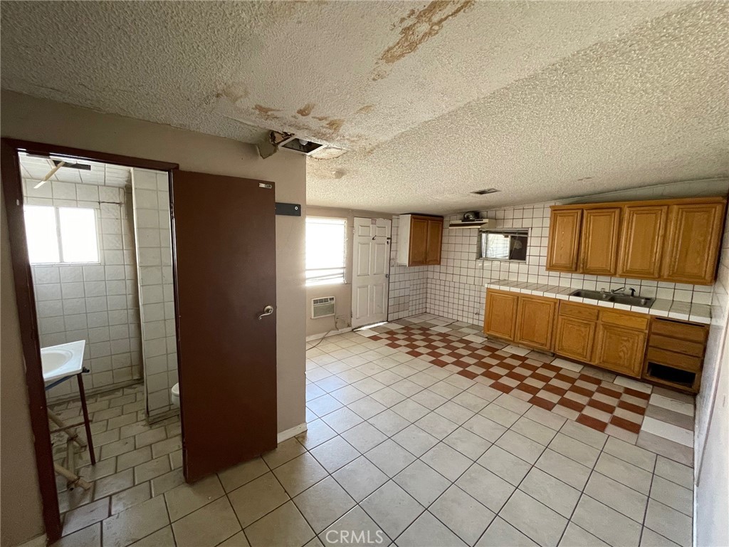 845 North Hagar Street San Fernando, CA 91340 - Photo 19 of 28 a bathroom with a sink a mirror and a shower