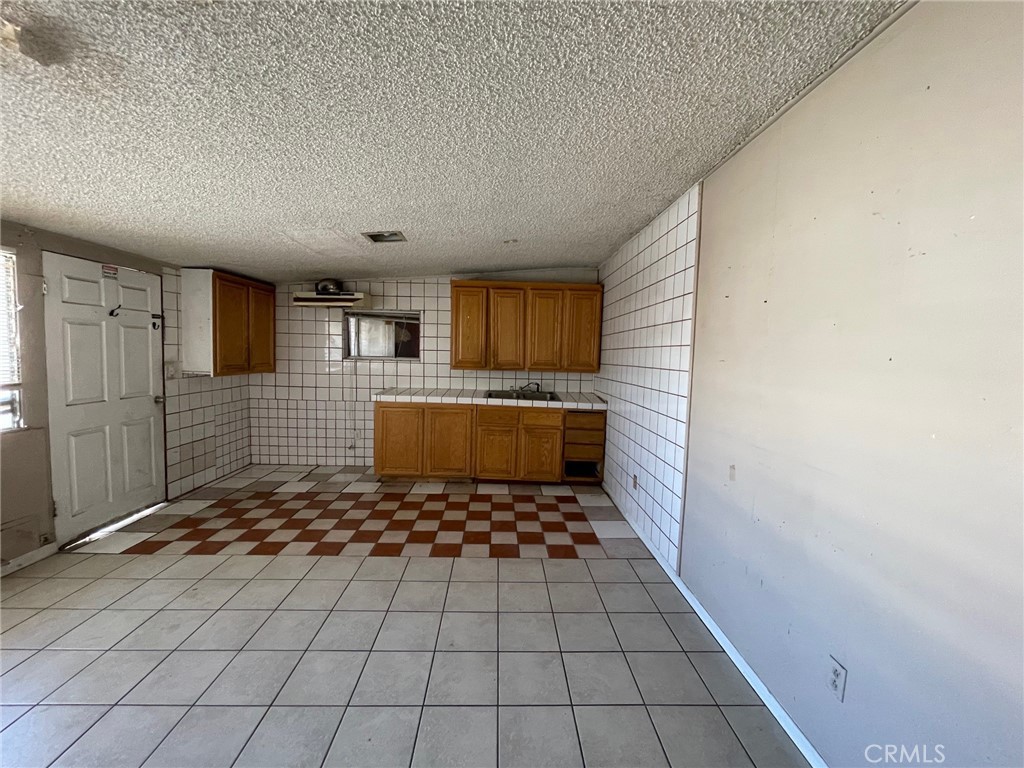 845 North Hagar Street San Fernando, CA 91340 - Photo 21 of 28 a bathroom with a sink a toilet and mirror