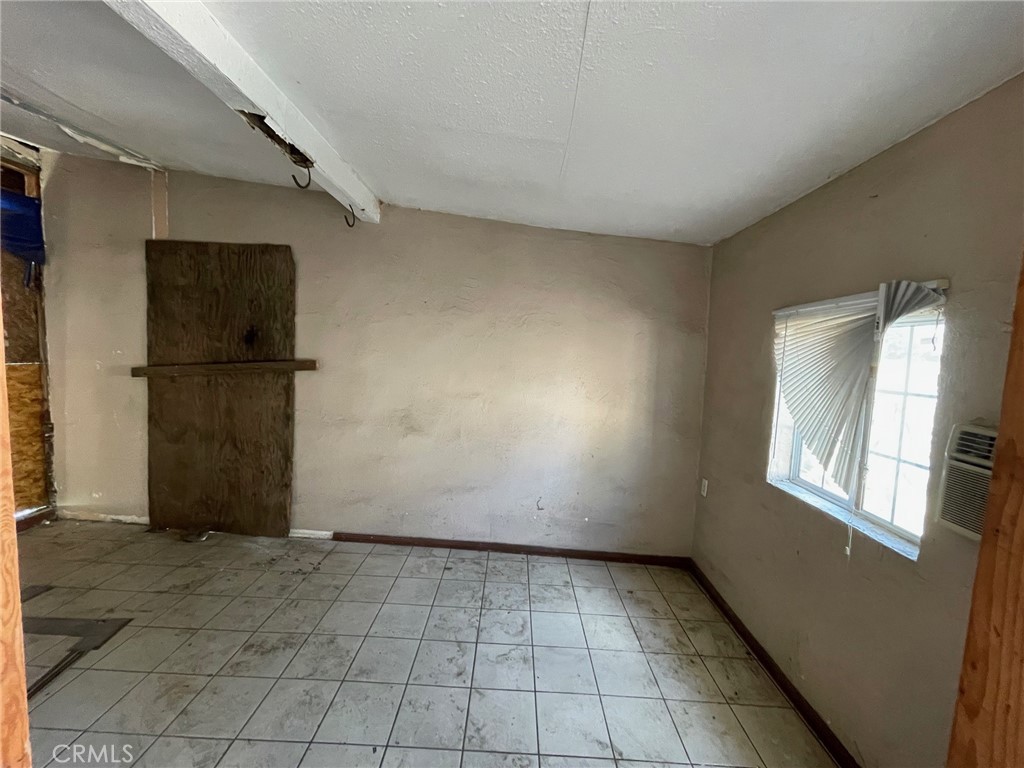 845 North Hagar Street San Fernando, CA 91340 - Photo 25 of 28 a view of a refrigerator in kitchen and an empty room