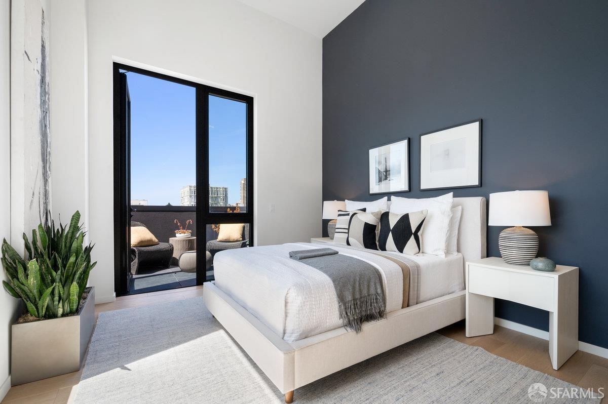 1523 Franklin Street, Unit PH8 San Francisco, CA 94109 - Photo 8 of 10 a bedroom with a large bed and a potted plant