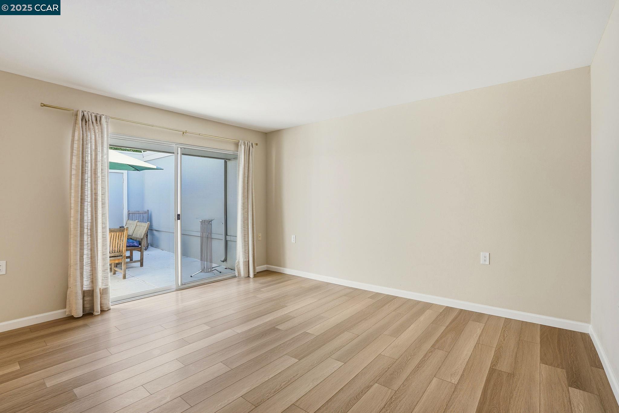2425 Pine Knoll Drive, Unit 1 Walnut Creek, CA 94595 - Photo 13 of 43 a view of a room with wooden floor and a window