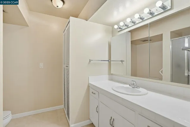 a bathroom with a sink double vanity and a mirror