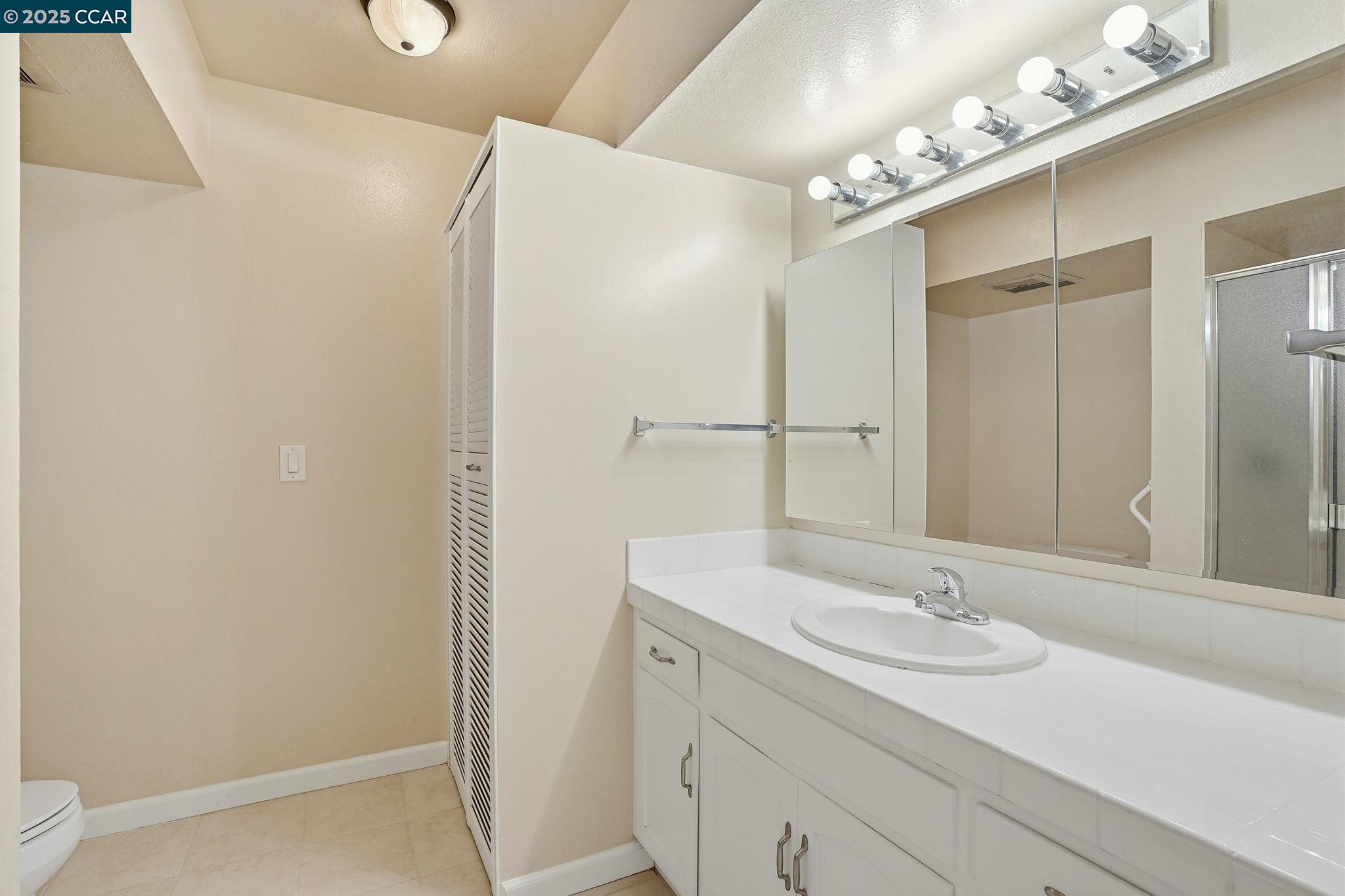 2425 Pine Knoll Drive, Unit 1 Walnut Creek, CA 94595 - Photo 14 of 43 a bathroom with a sink double vanity and a mirror