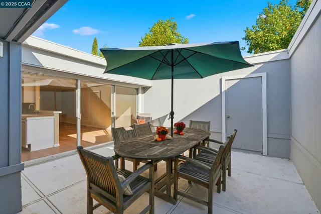a view of an outdoor space with furniture and umbrella