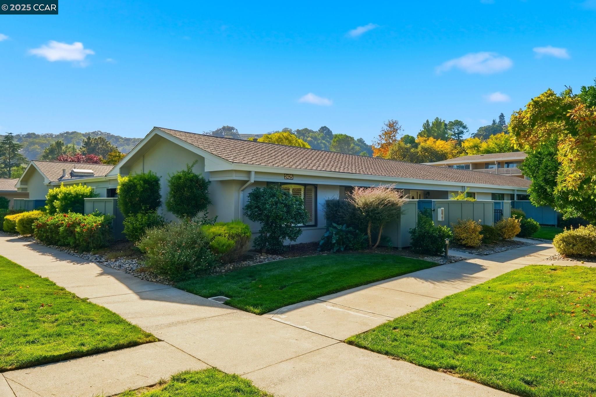 2425 Pine Knoll Drive, Unit 1 Walnut Creek, CA 94595 - Photo 23 of 43 a front view of a house with garden
