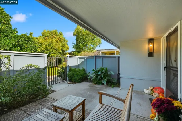 a backyard of a house with wooden floor a yard and outdoor seating