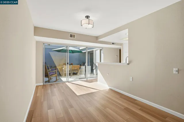 a view of a room with wooden floor and white walls