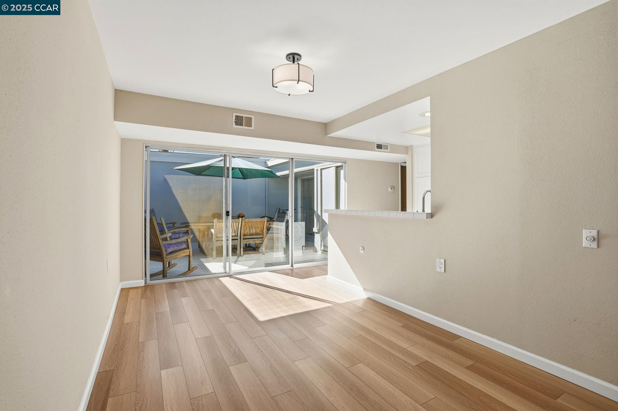 2425 Pine Knoll Drive, Unit 1 Walnut Creek, CA 94595 - Photo 9 of 43 a view of a room with wooden floor and white walls