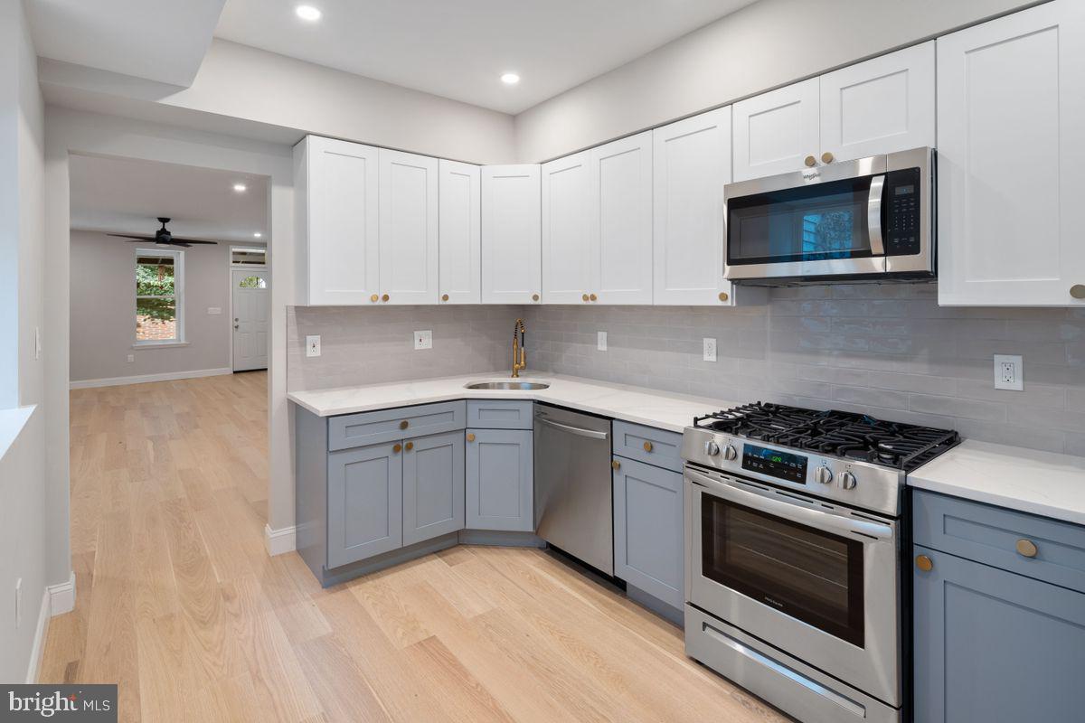 a kitchen with granite countertop a stove and a sink