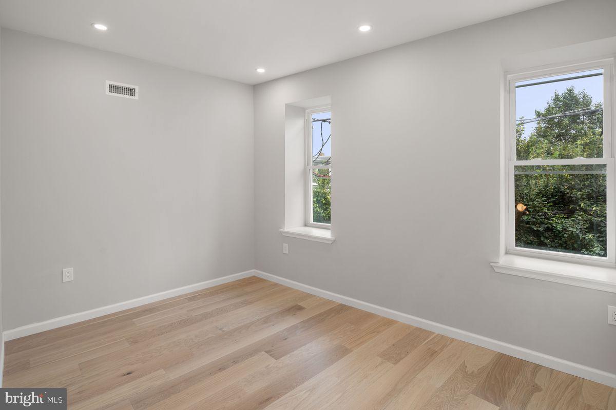 4129 Terrace Street Philadelphia, PA 19128 - Photo 22 of 27 an empty room with wooden floor and windows