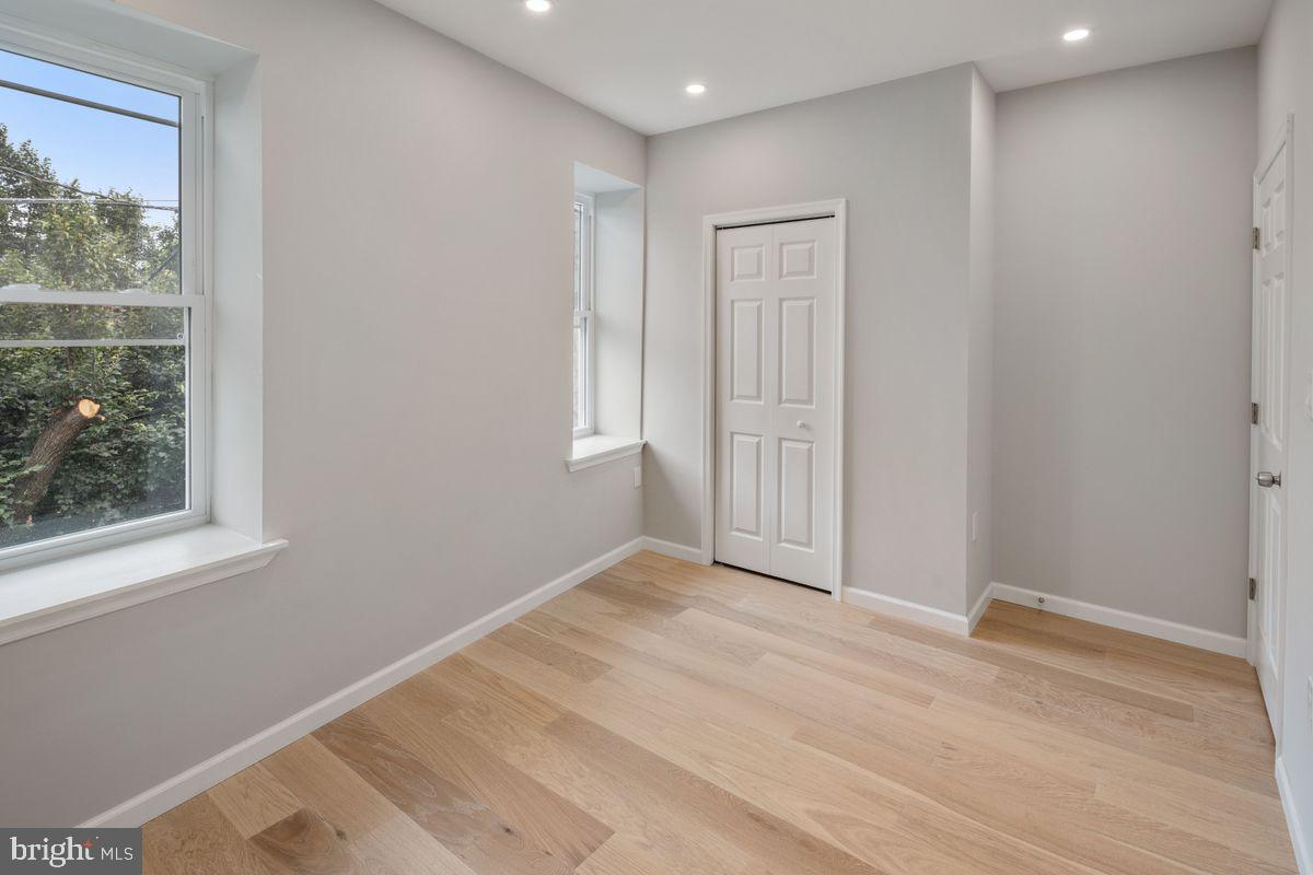 4129 Terrace Street Philadelphia, PA 19128 - Photo 23 of 27 an empty room with wooden floor and windows