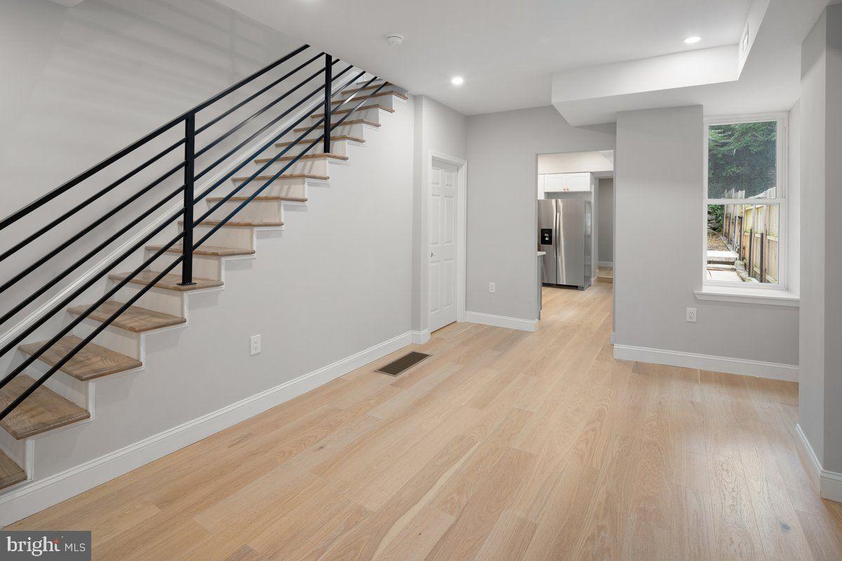 4129 Terrace Street Philadelphia, PA 19128 - Photo 6 of 27 a view of an empty room with wooden floor and stairs