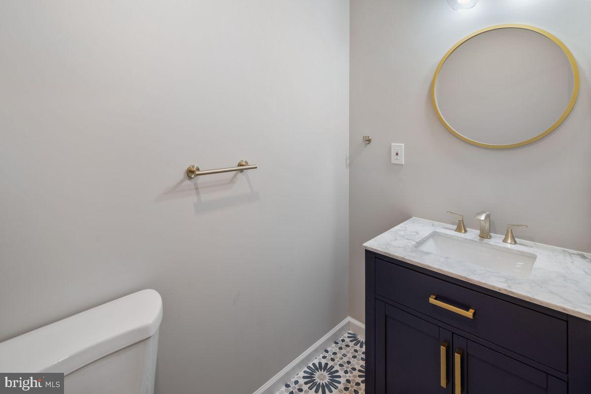 4129 Terrace Street Philadelphia, PA 19128 - Photo 9 of 27 a bathroom with a toilet sink vanity and mirror