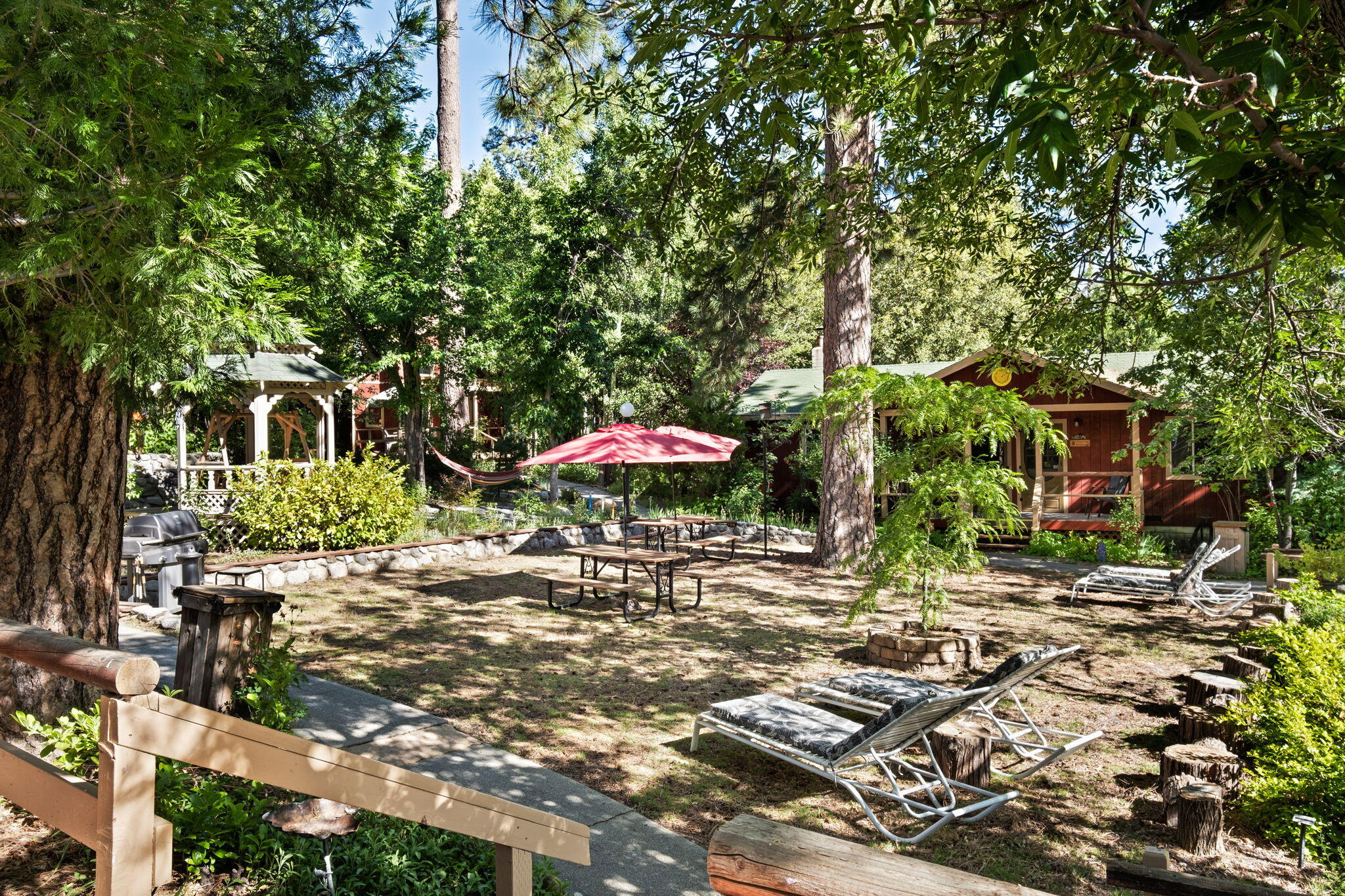 25210 Fern Valley Road Idyllwild, CA 92549 - Photo 110 of 127 a patio with table and chairs under an umbrella
