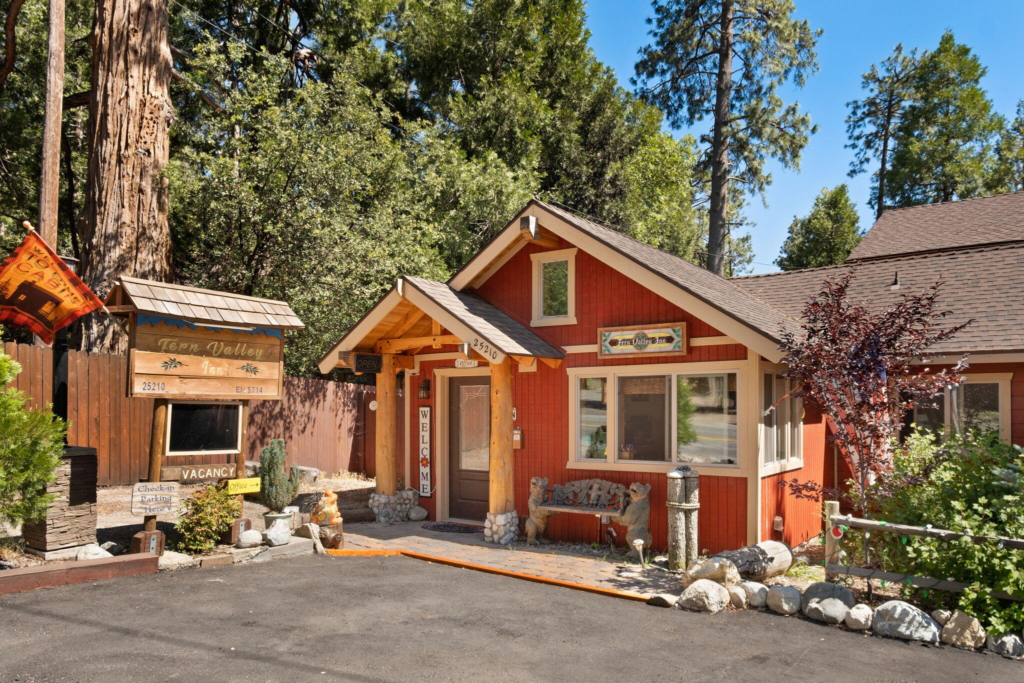 25210 Fern Valley Road Idyllwild, CA 92549 - Photo 17 of 127 a front view of a house with a yard and glass windows