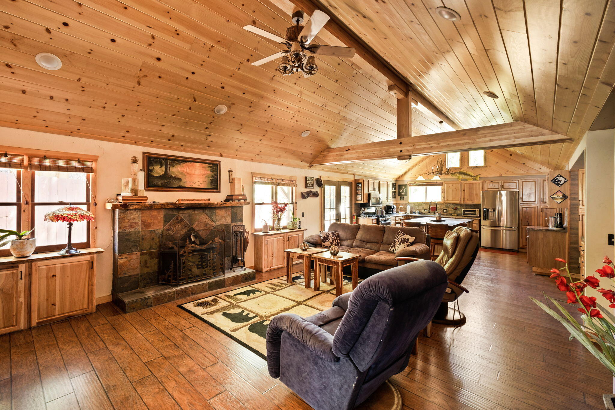 25210 Fern Valley Road Idyllwild, CA 92549 - Photo 20 of 127 a living room with furniture a fireplace and a flat screen tv