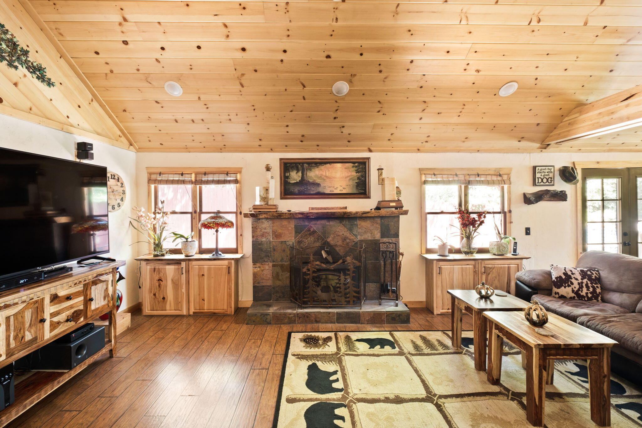 25210 Fern Valley Road Idyllwild, CA 92549 - Photo 21 of 127 a living room with furniture a flat screen tv and a fireplace