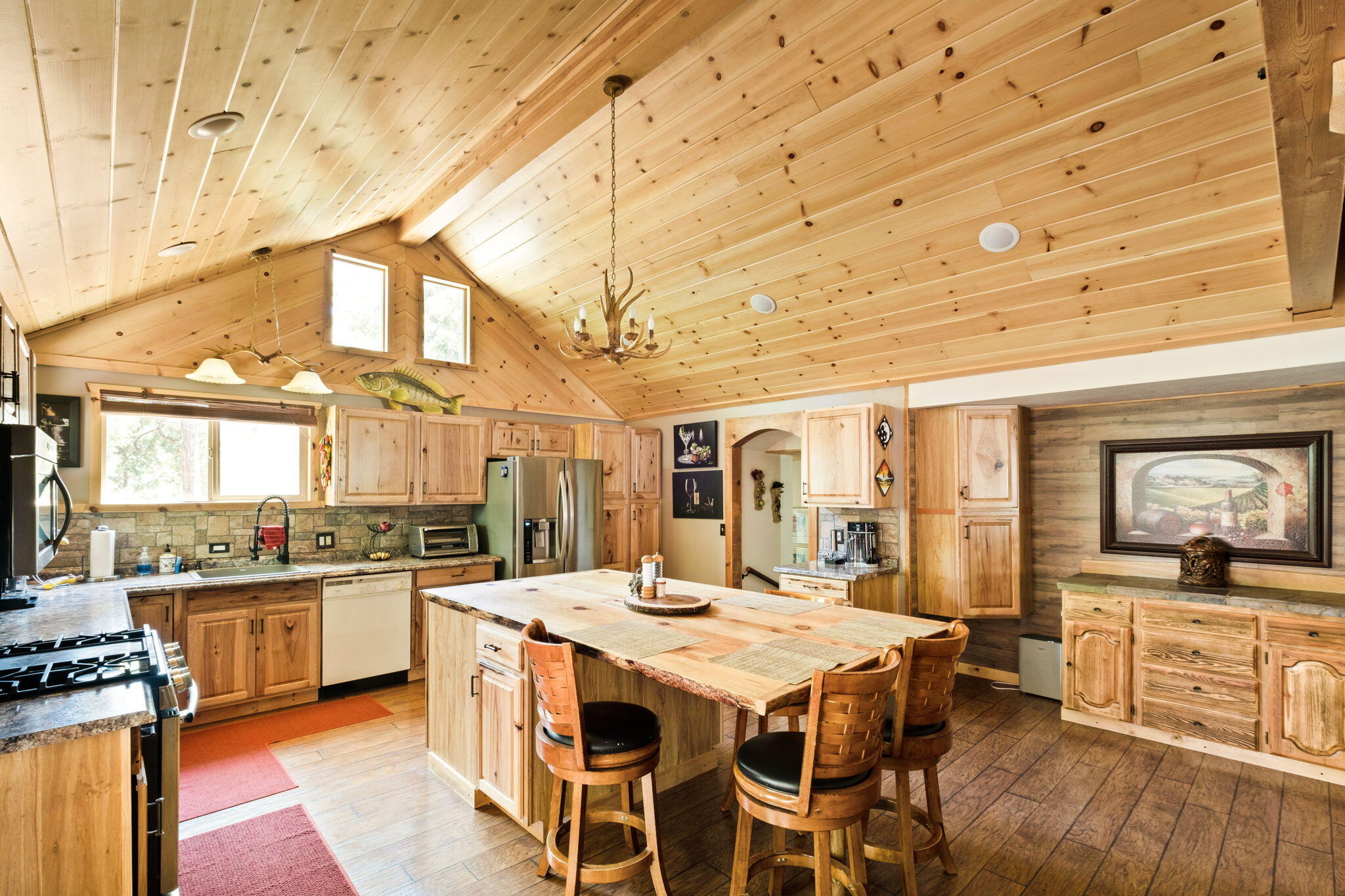 25210 Fern Valley Road Idyllwild, CA 92549 - Photo 23 of 127 a large kitchen with a table and chairs