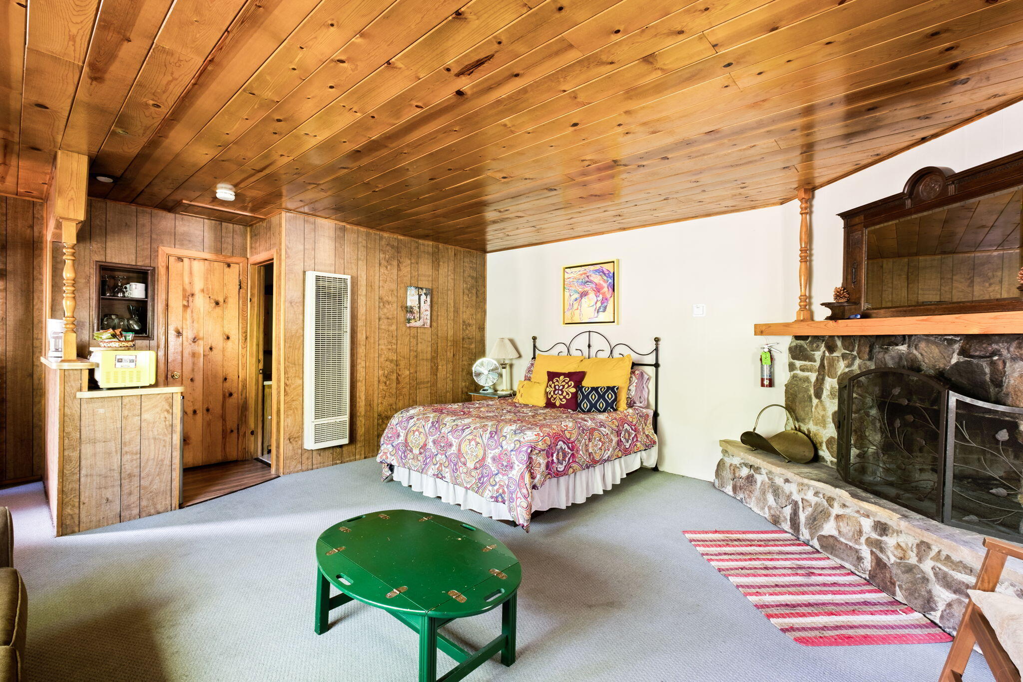 25210 Fern Valley Road Idyllwild, CA 92549 - Photo 55 of 127 a bedroom with furniture and a flat screen tv