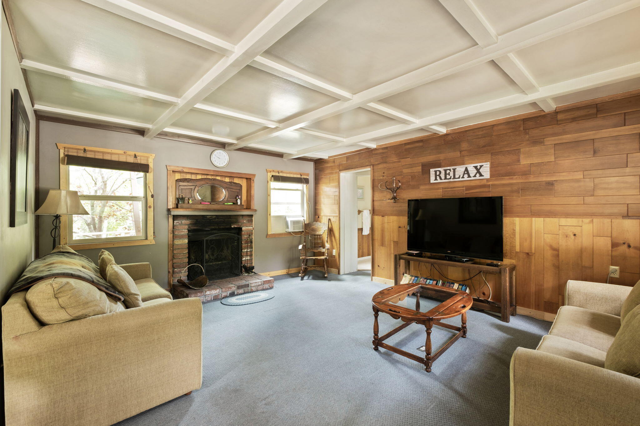 25210 Fern Valley Road Idyllwild, CA 92549 - Photo 84 of 127 a living room with furniture a fireplace and a flat screen tv