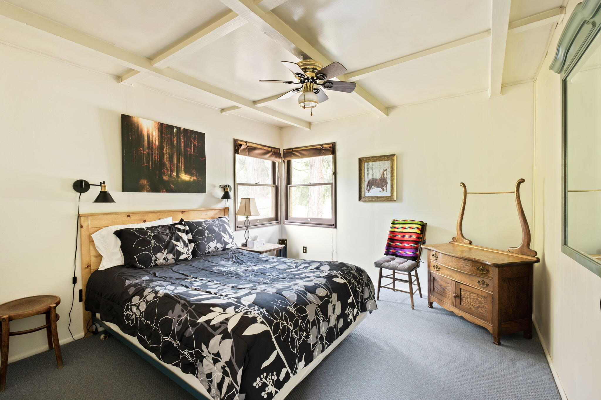 25210 Fern Valley Road Idyllwild, CA 92549 - Photo 88 of 127 a bedroom with a bed and a flat tv screen on dresser