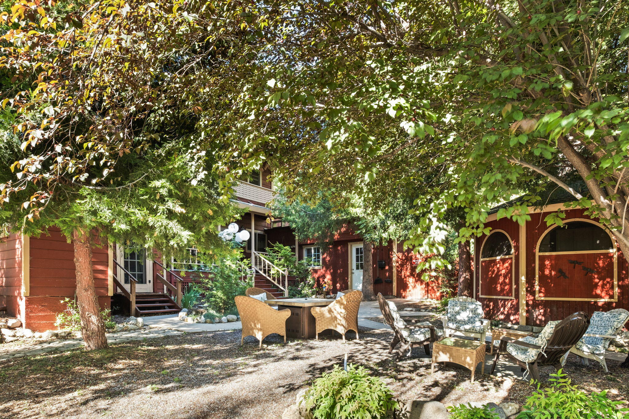 25210 Fern Valley Road Idyllwild, CA 92549 - Photo 95 of 127 a view of a patio with table and chairs and potted plants and large tree