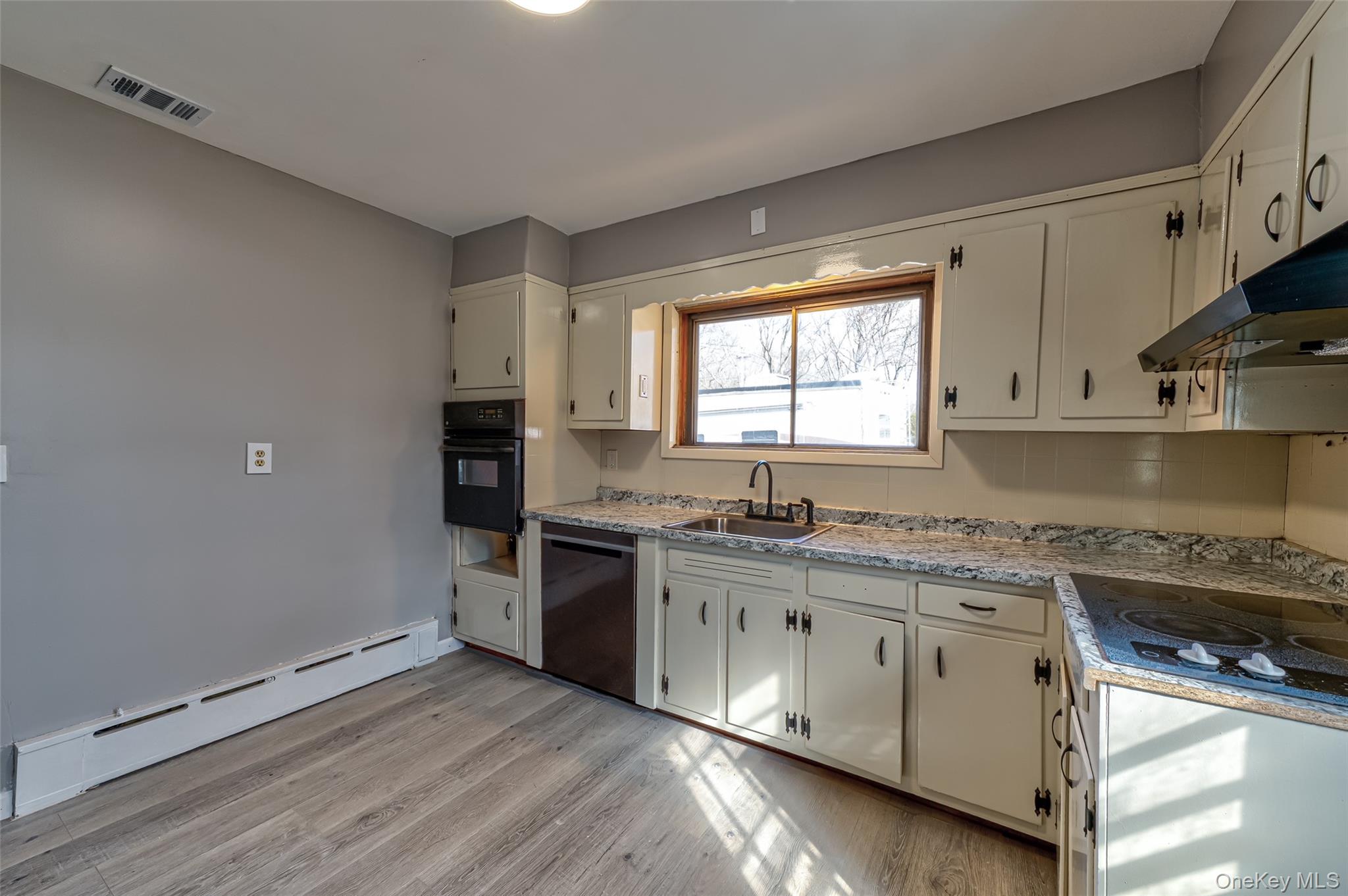 157 Hawthorne Street Mastic, NY 11950 - Photo 11 of 12 a kitchen with granite countertop white cabinets and white appliances