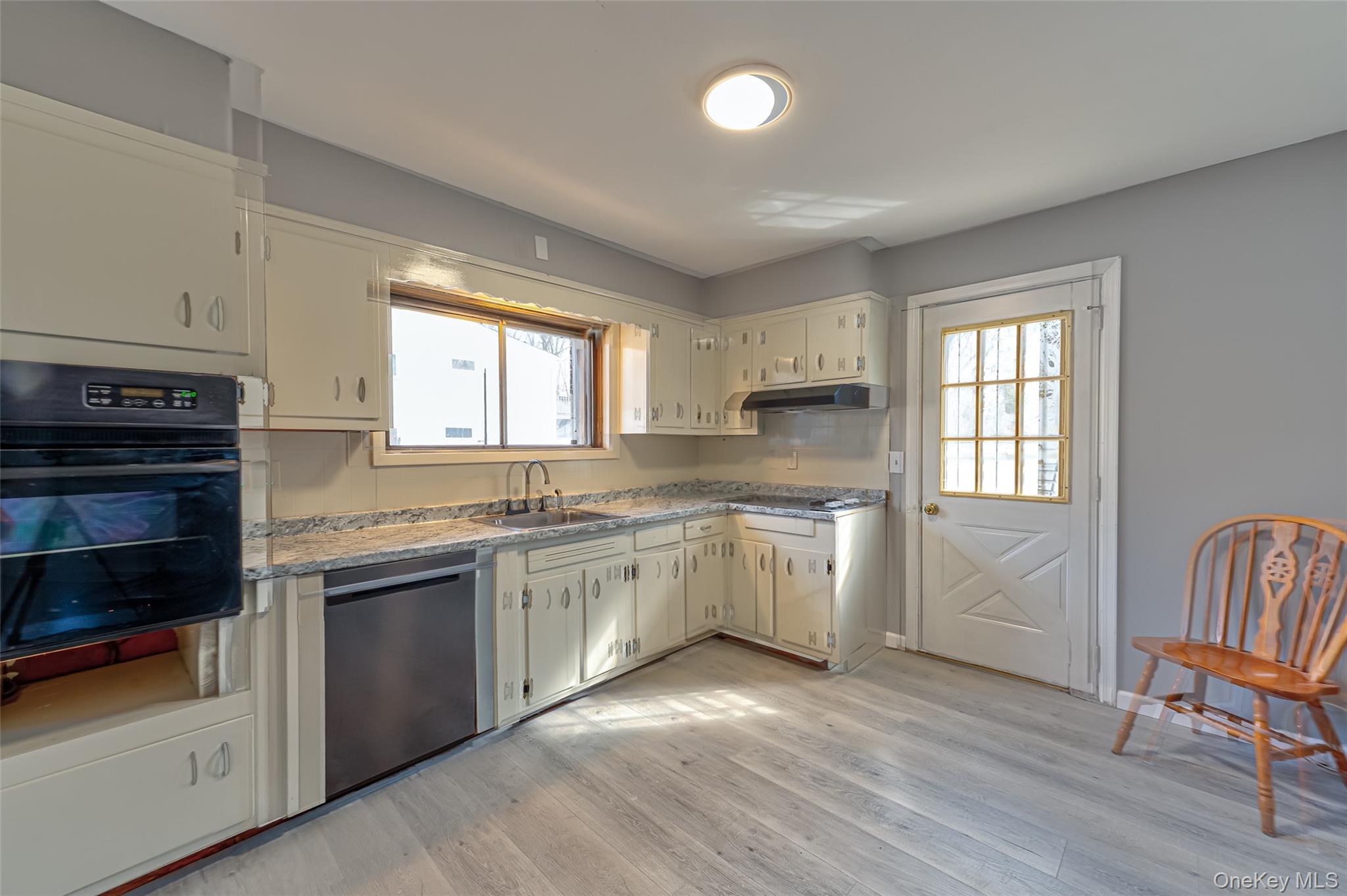 157 Hawthorne Street Mastic, NY 11950 - Photo 6 of 12 a kitchen with granite countertop white cabinets and white appliances