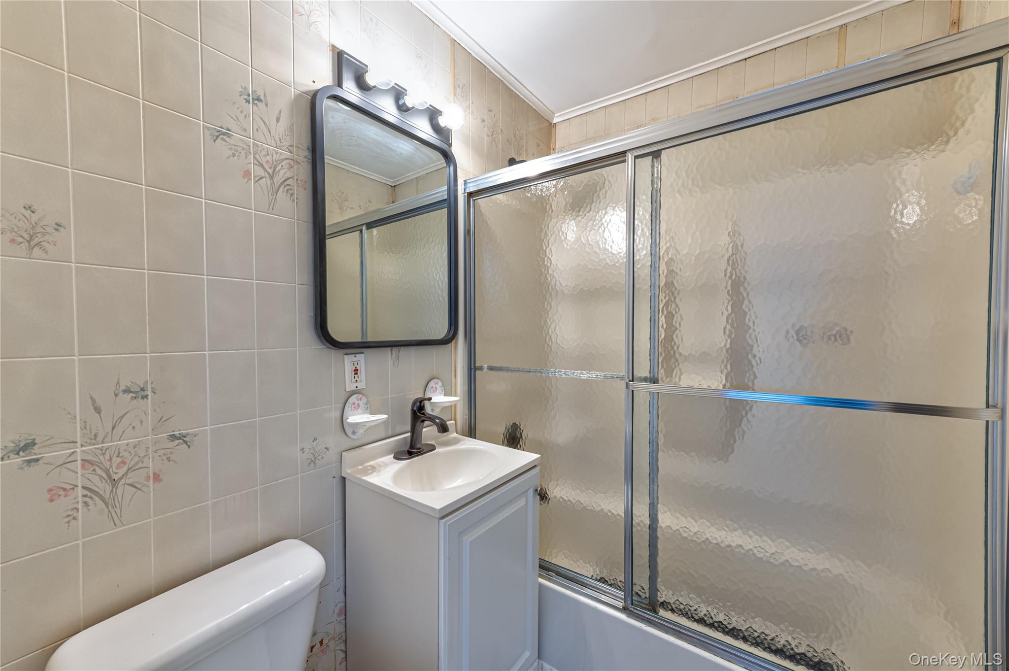 157 Hawthorne Street Mastic, NY 11950 - Photo 9 of 12 a bathroom with a sink toilet and shower