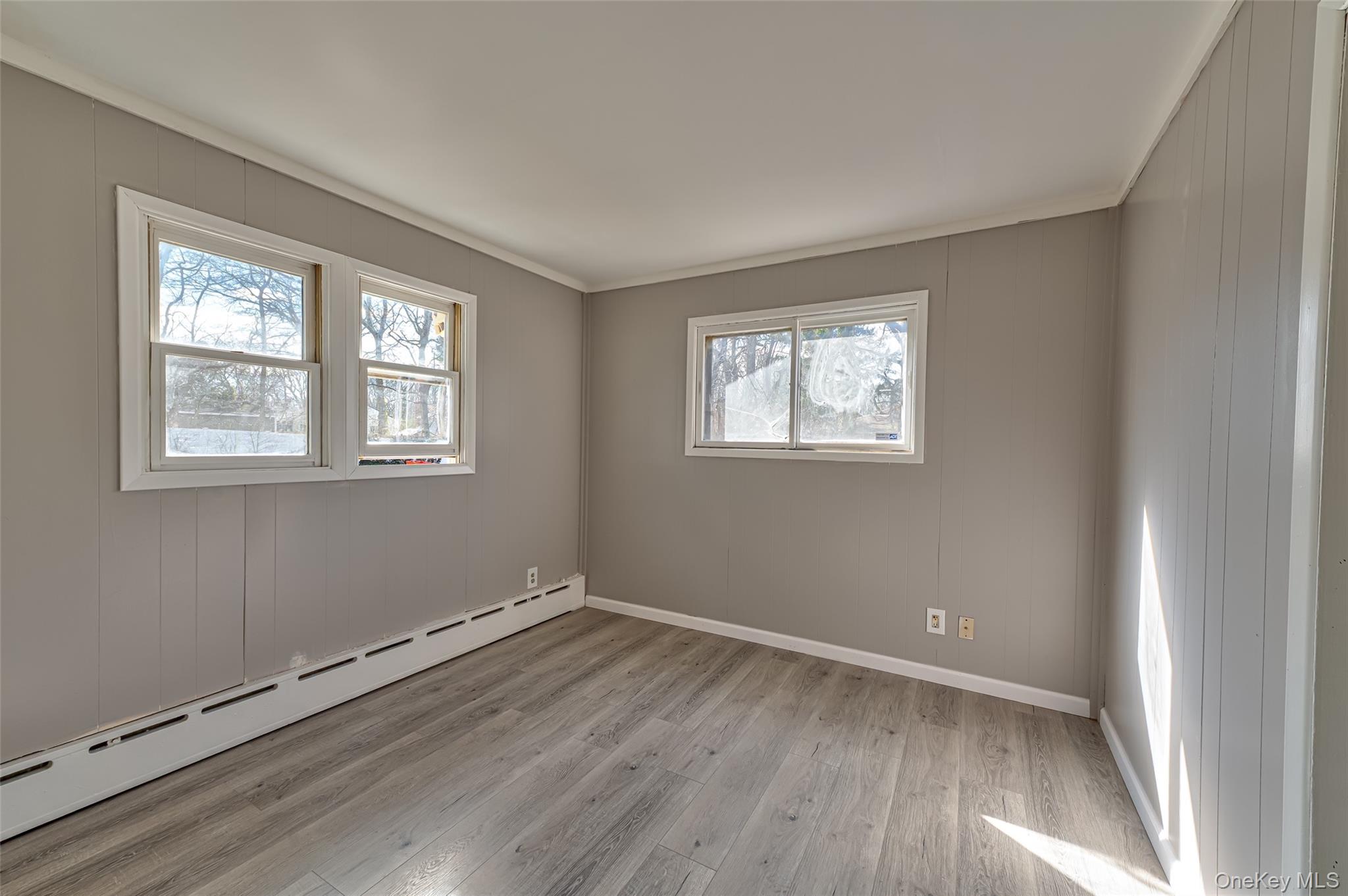 157 Hawthorne Street Mastic, NY 11950 - Photo 10 of 12 a view of a room with wooden floor and windows