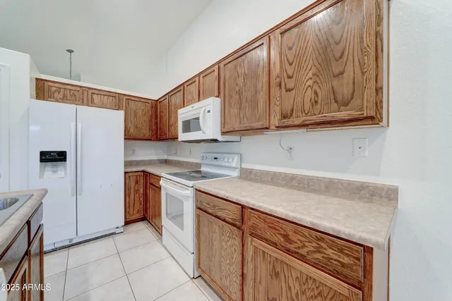 a kitchen with stainless steel appliances granite countertop a refrigerator sink and cabinets