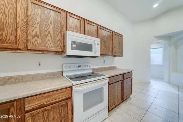 a kitchen with stainless steel appliances granite countertop a stove a microwave and a sink