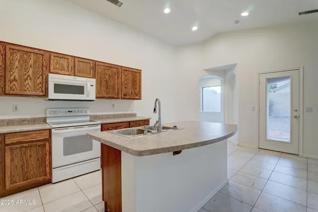 a kitchen with a sink cabinets and window