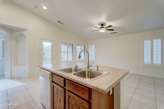 a kitchen that has a sink and a chandelier