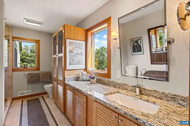 a spacious bedroom with a bed and a window