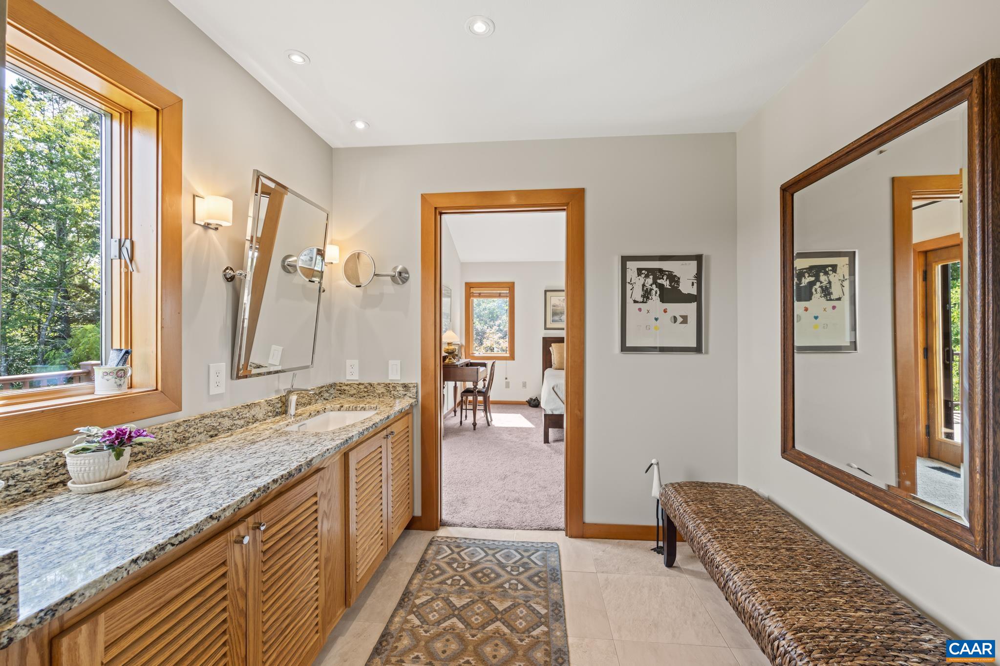 456 Roberts Mountain Road Faber, VA 22938 - Photo 38 of 59 a spacious bathroom with a granite countertop tub sink and mirror