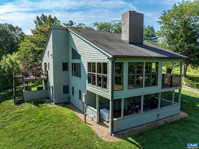 a view of house with backyard outdoor seating and green space