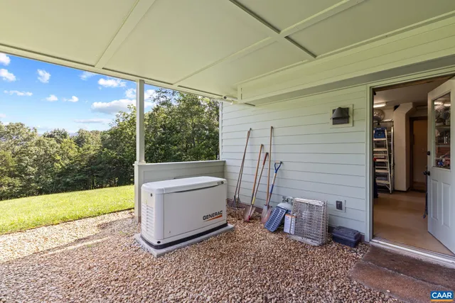 an aerial view of green landscape with trees houses and mountain view