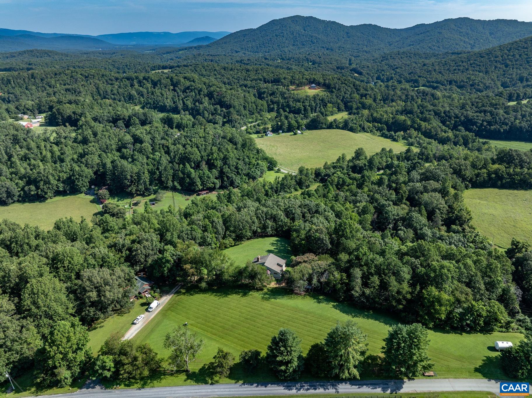 456 Roberts Mountain Road Faber, VA 22938 - Photo 50 of 59 an aerial view of green landscape with trees houses and mountain view
