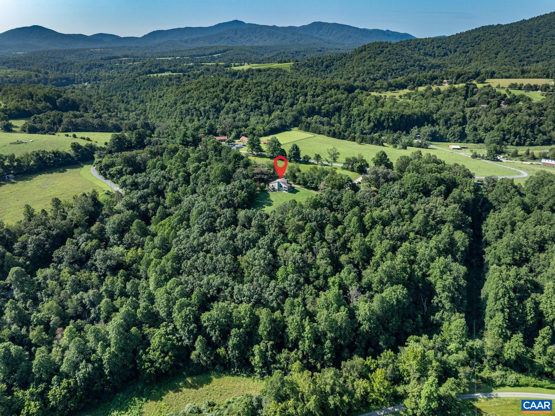456 Roberts Mountain Road Faber, VA 22938 - Photo 56 of 59 an aerial view of green landscape with trees houses and mountain view