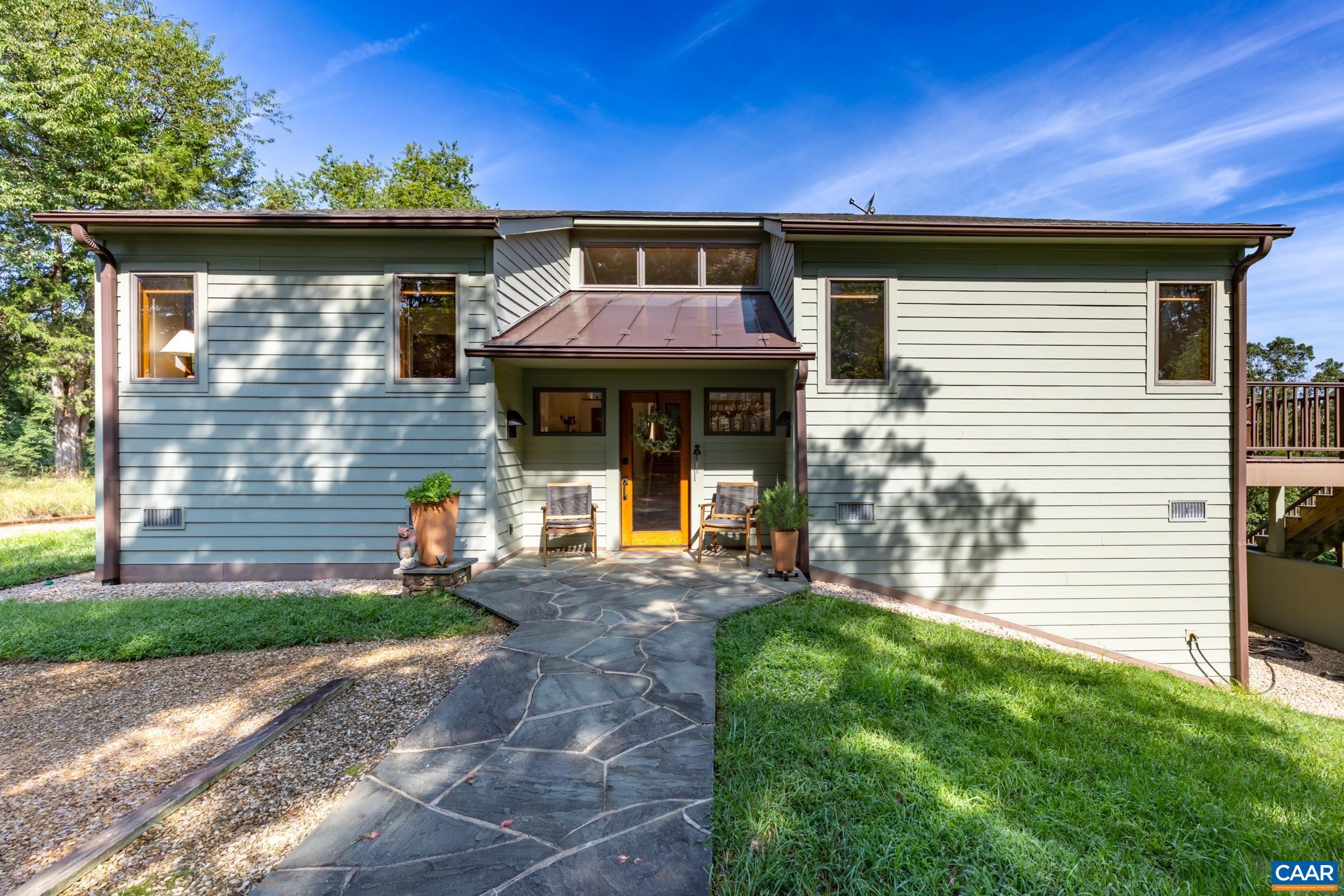 456 Roberts Mountain Road Faber, VA 22938 - Photo 9 of 59 a front view of a house with garden